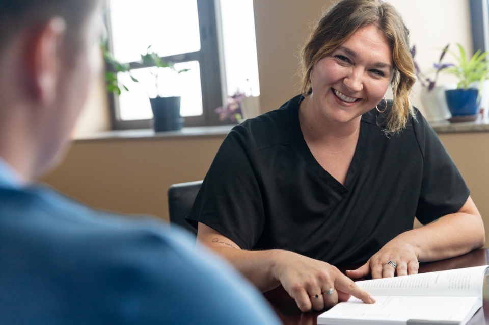 Mesothelioma Advocate Morgan Grebing, RN, smiling while talking with a client