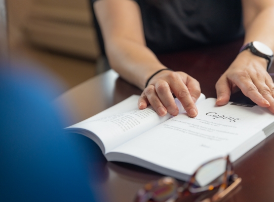 a Mesothelioma Advocate shows a client the section on coping strategies in MRHFM's mesothelioma support materials