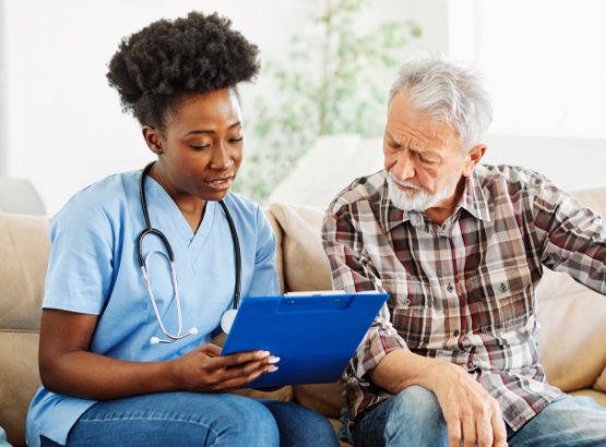 a caregiver holds a patient's hands